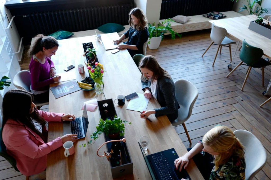 Diverse women working together at a shared table